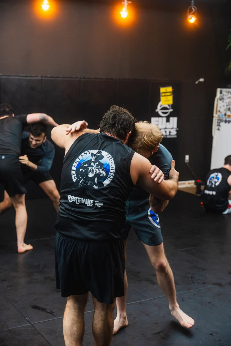 Adults practicing a standing Jiu Jitsu drill at Speak Easy